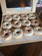 Afbeelding in Gallery-weergave laden, Luxe doos met 12 ambachtelijke bruiloft donuts voorzien van wit glazuur, gouden details, witte suikerparels en een subtiele gouden glans.
